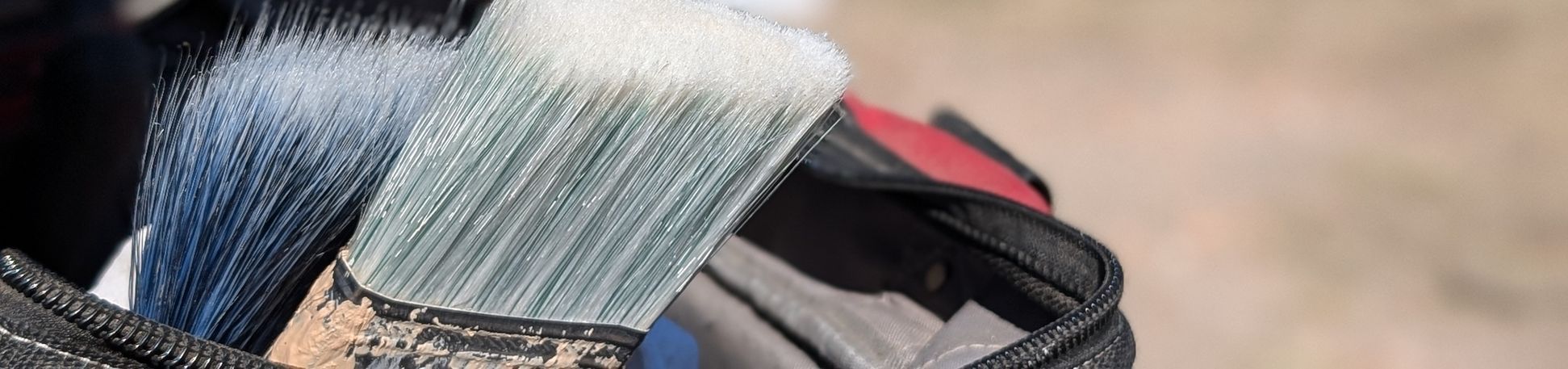 paint brushes in a tool bag