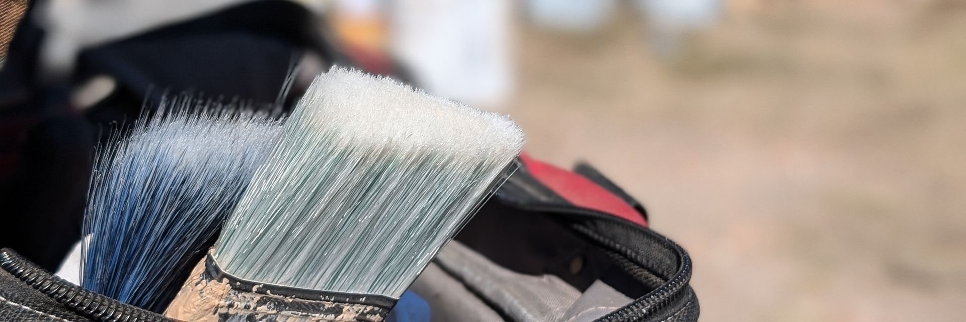 paint brushes in a tool bag